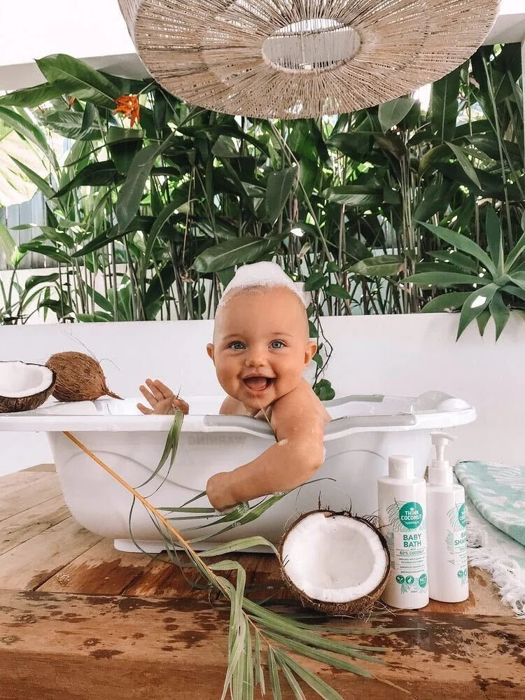 Baby in bath with Think Coconut products