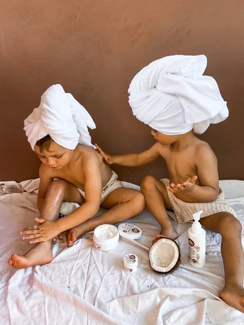 Brothers applying Think Coconut lotion